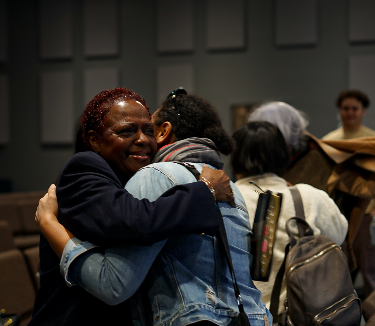Church members sharing a warm embrace at Rebirth Nation
